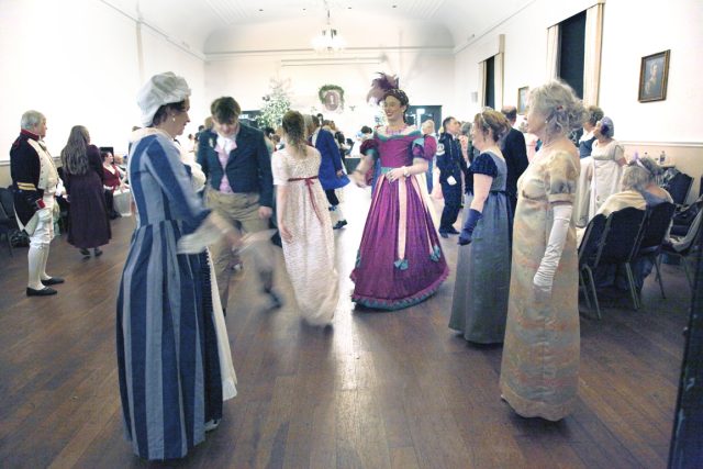 Ball goers are all smiles during a Hay as we look up the set to the band playing below the portrait of John Playford. Assembly House, 2025