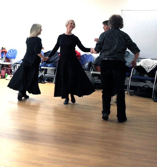 All smiles as the ladies dance the Ladies Chain as part of the 'Figure' in a Cotillion taught by Sam Gosk in his workshop, 'Allemande and the Cotillions'.