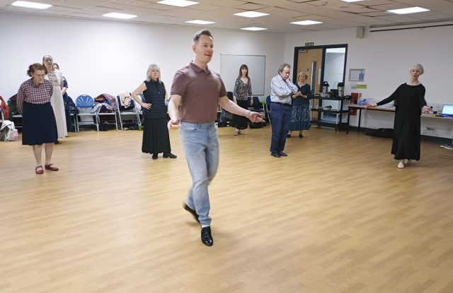 Sam Gosk demonstrates steps in a dance at the start of the weekends workshop 'The Allemande and the Cotillion'