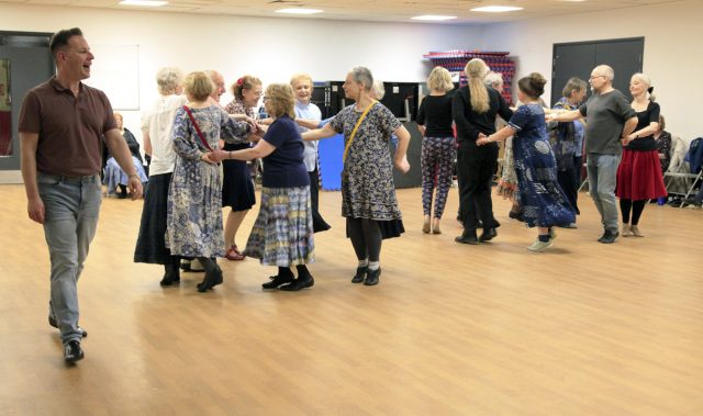 Tutor Sam Gosk calls the moves during a complicated manoeuver in a Cotillion